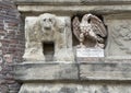 Carved stone eagle sculpture on the front facade of the d\'Accursio Palace in Bologna, Italy.