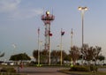 Original DFW Airport beacon & four flagpoles with flags at Founder`s Plaza Observation Area at DFW Airport.