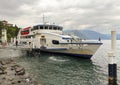 The Orion, a large modern ferry boat of Navigazione Laghi leaving the dock at Varenna on Lake Como.