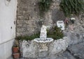 Ornate drinking fountain with small statue of a cherub holding a dolphin, Marina Grande, Sorrento Royalty Free Stock Photo