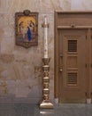 Ornate lamp and the 14th Station of the Cross inside Christ the King Church in Dallas, Texas. Royalty Free Stock Photo