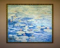 Painting featuring water lilies with red flowers floating in blue water on display in a resort on the Big Island, Hawaii.