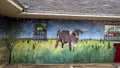 Painting of a longhorn steer on the brick sidewall of a gas station on Route 66 in Luther, Oklahoma.
