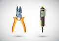 Pictured are a pair of diagonal pliers and a voltage tester. The Royalty Free Stock Photo
