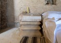 Bedroom with a bed of rammed cotton and a bedside table of salt at the Adrere Amellal eco-lodge in the Siwa Oasis, Egypt.