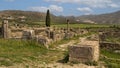 Peristyle house ruins along the Decumanus Maximus at the Archaeological Site of Volubilis in Morocco.