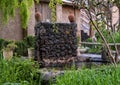 Pond, stone fountain and vegetation at the Kasbah Du Toubkal in the High Atlas Mountains of Morocco.