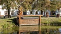 Pond and wooden sculpture water goblin, The Village of Holasovice, Czech Republic Royalty Free Stock Photo