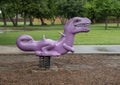 Purple dinosaur ride in children`s area Shepherd`s Glen Park in Frisco, Texas.