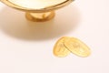 Replica pure gold coins called koban in japan and gold sake cup Royalty Free Stock Photo