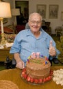 Retired family physician with a thumbs up celebrating his 87th birthday.