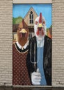 Chickens mimicking the farmer and his wife in the famous painting, American Gothic by Grant Wood. Royalty Free Stock Photo