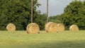 Round hay bales scattered in the field after harvesting in the State of Oklahoma in the United States of America. Royalty Free Stock Photo