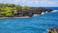 Rugged lava shoreline next to the Black sand beach on the Island of Maui in the State of Hawaii.