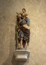 `Saint Christopher`, a limewood with paint and gilding statue circa 1520, on display in the Cloisters in New York City. Royalty Free Stock Photo