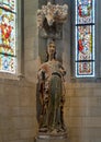 `Saint Petrolina`, a Catalan limestone sculpture with paint under a stone vaulted canopy in the Cloisters in New York City.