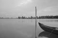 Black and white photo from Lake banks with a partial view of the fishing boat and coconut trees