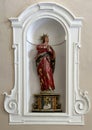Sculpture of Mother of Sorrows in a niche on a side wall of the Church of St. Mary of Graces in Varenna, Italy.