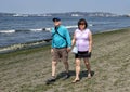 Husband and wife on vacation enjoying a walk on Alki Beach, Seattle, Washington Royalty Free Stock Photo