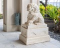 White marble statue of a male Chinese Ching Dynasty guardian Lion in a resort on Maui.