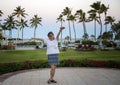 Sixty-three year-old female Korean tourist excited about the morning at a Hawaiian resort on the Big Island, Hawaii.
