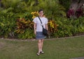 Sixty-three year-old female Korean tourist standing at a Hawaiian resort in the age of COVID on the Big Island, Hawaii.