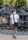 Sixty-three year-old female Korean tourist standing at a Hawaiian resort in the age of COVID on the Big Island, Hawaii.
