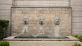 Fountain with three identical lion heads with human faces in Dallas, Texas