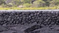 Small portion of the Kaloko Fishpond kuapa or seawall made of interlocking lava rocks on the Big Island, Hawaii.