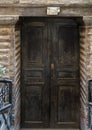 Worn sign and wooden doors for the Cavern Church known as Abu Serga in Coptic Christian Cairo, Egypt. Royalty Free Stock Photo