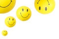 Smiley shaped balloons in a white background