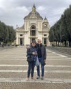 Smiling female Korean tourist in front of the Basilica of Saint Mary of the Angels just outside Assisi, Italy.