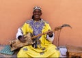 Moroccan street musician playing the sintir in Marrakesh