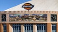 South facade of Dickies Arena with `Los Caballeros` mural by William Matthews flanked by bas-relief sculptures by Buckeye Blake.