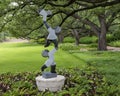 Springstone sculpture titled Acrobats by Dominic Benhura in the Fort Worth Botanic Garden.