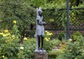 Springstone sculpture titled Studying by Jonothan Mhondorohuma in the Fort Worth Arboretum.