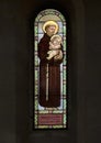 Stained glass of Saint Anthony of Padua holding the Infant Jesus in the Holy Savior Church in Castellina in Chianti, Italy.with
