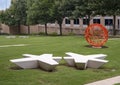Star shaped stone seating and an abstract round orange painted metal sculpture in the Telecom Corridor in Richardson, Texas.