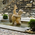 Statue of a cherub with a large waterfowl in a small fountain at the entrance to Villa Cipressi in Varenna on Lake Como.