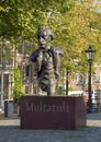 Statue Multatuli on a canal bridge in Amsterdam, The Netherlands