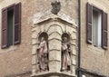 Statue of Saint Anthony of Padua and another Franciscan Friar in abutting niches in Bologna, Italy.