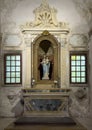 Statue of Madonna standing and holding the Child Jesus in the Basilica of Saint Apollinare Nuovo in Ravena, Italy.