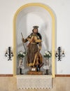 Statue of San Roque in a niche on the left side of the interior of the Chapel of San Juan de Letran in Zahara de la Sierra, Cadiz.