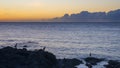 Sunset over the Pacific Ocean viewed from the shoreline of the Big Island, Hawaii. Royalty Free Stock Photo