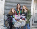 Teenage girls posing for a donation with Diva and Chloe in South Philadelphia Royalty Free Stock Photo