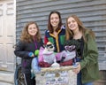 Teenage girls posing for a donation with Diva and Chloe in South Philadelphia Royalty Free Stock Photo