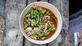 Pictured top view: Thai food stir-fried with chili paste, chicken, and yardlong bean in a wooden cup