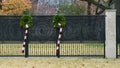 Two Chistmas candy canes hanging from green wreathes decorating a fence in Dallas, Texas