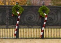 Two Chistmas candy canes hanging from green wreathes decorating a fence in Dallas, Texas Royalty Free Stock Photo