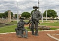 Two cowboys in a Cowboy camp, part of the longest bronze sculpture collection in the United States in The Center at Preston Ridge. Royalty Free Stock Photo